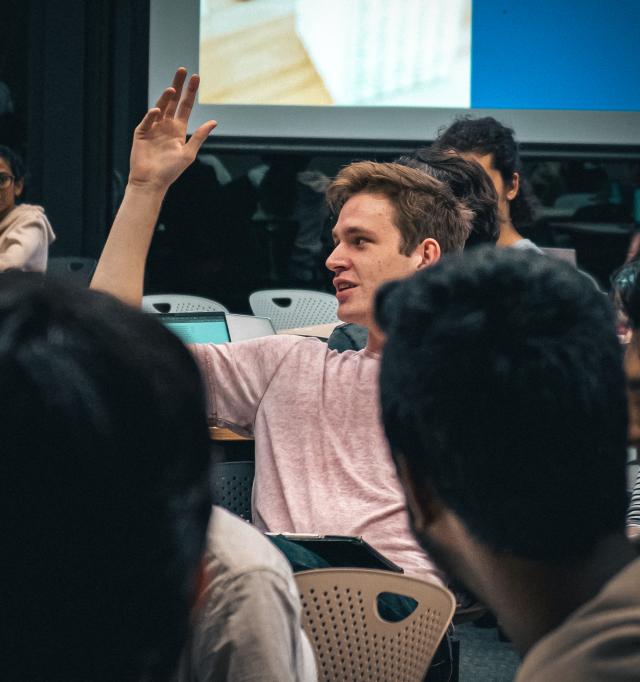A student putting their hand up during a workshop